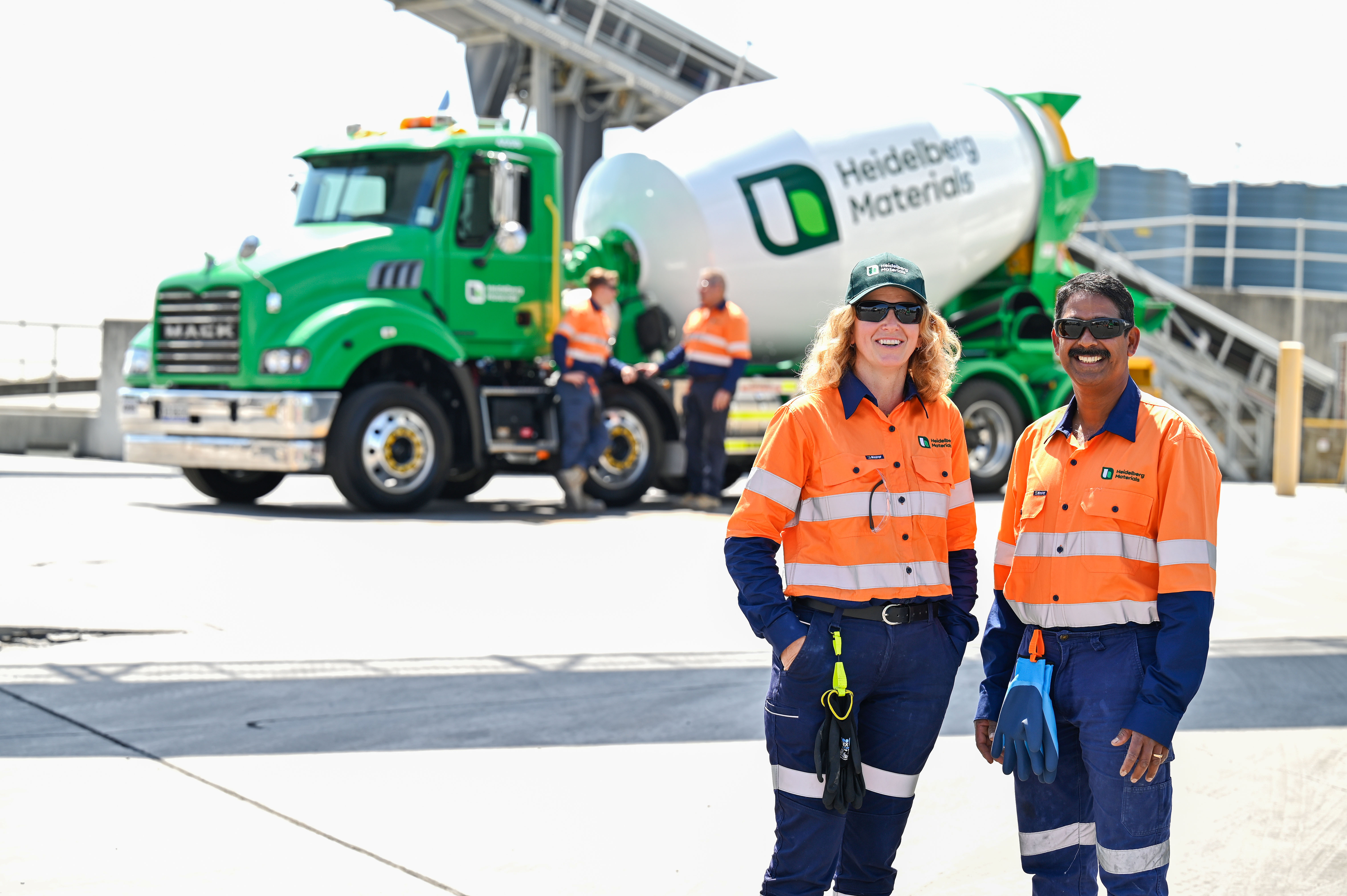 Two employees standing in front of truck