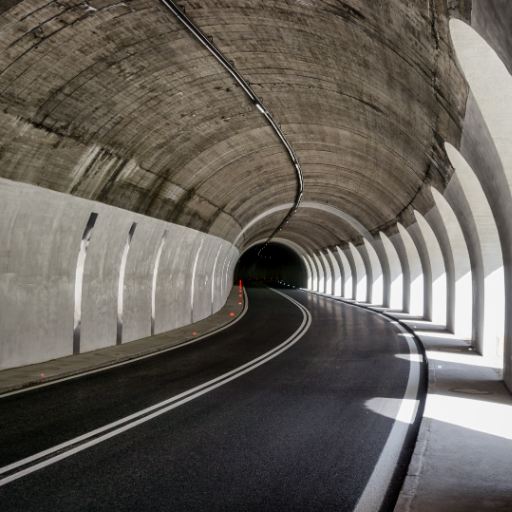 Concrete tunnel structure with curved roadway, showcasing durable, high-performance concrete used in infrastructure applications