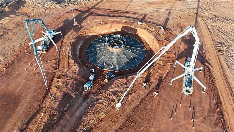 Mobile concrete batching plant operating on a remote construction site.