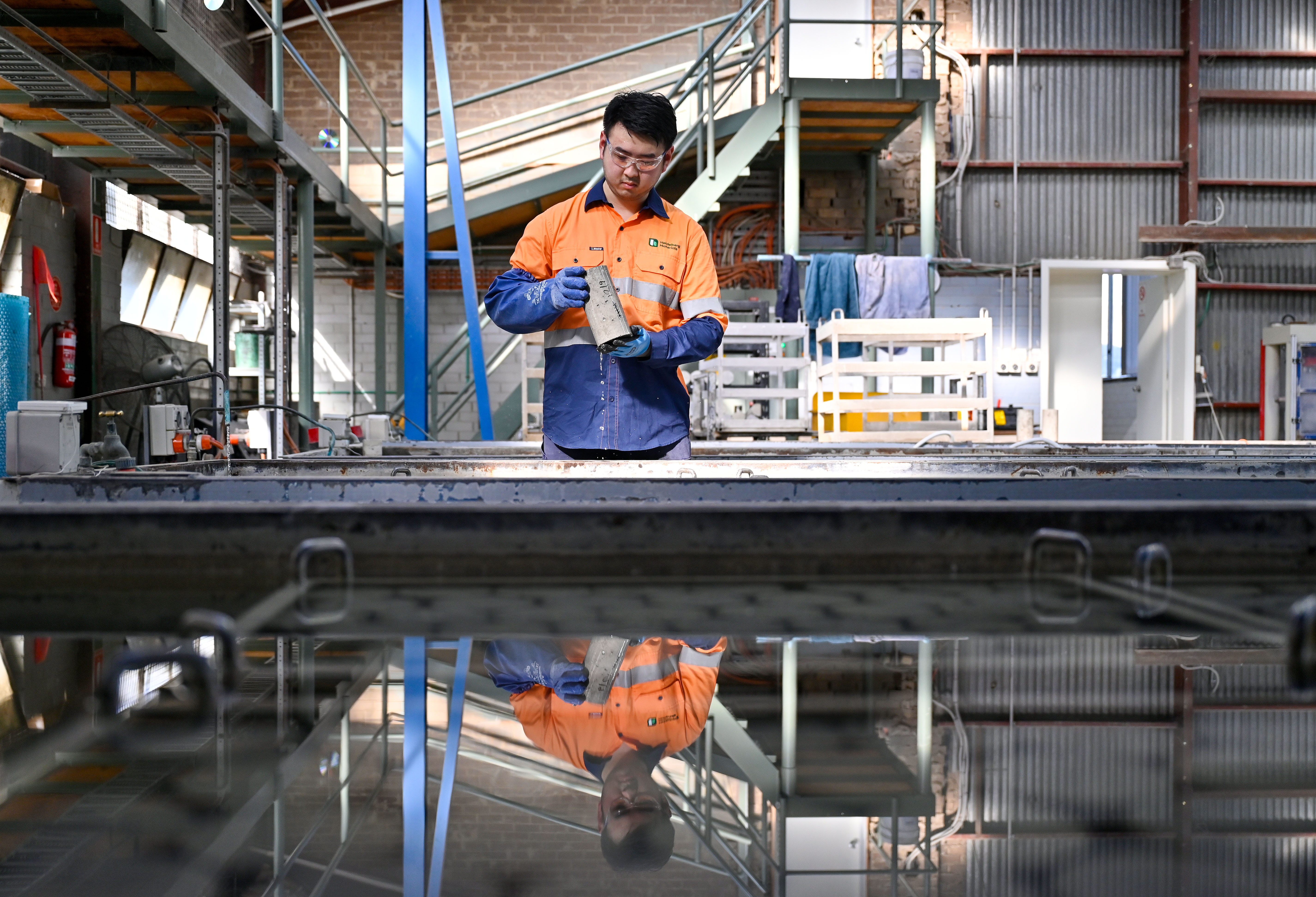 Heidelberg Materials laboratory technician preparing and testing material samples in a quality control laboratory to ensure product performance and compliance.