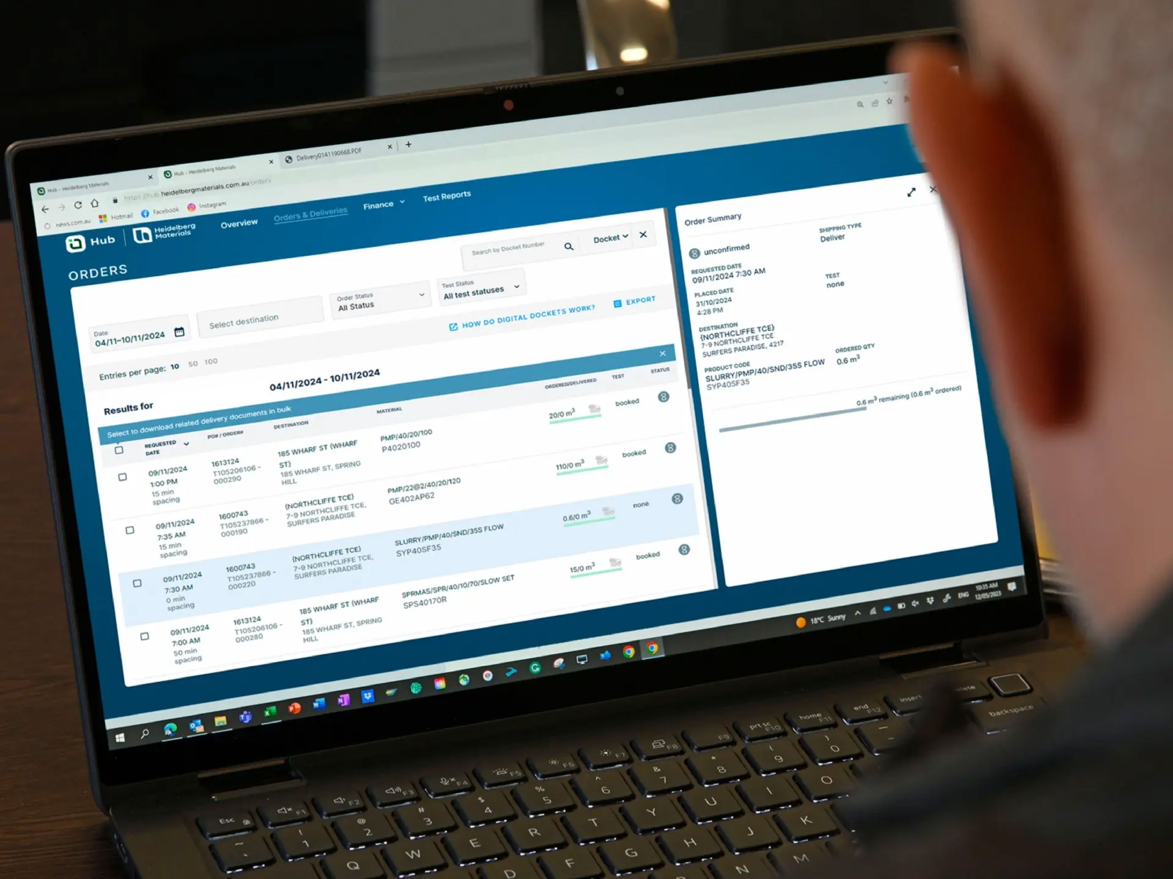 Man reviewing upcoming orders in Heidelberg Materials' Hub web portal. 