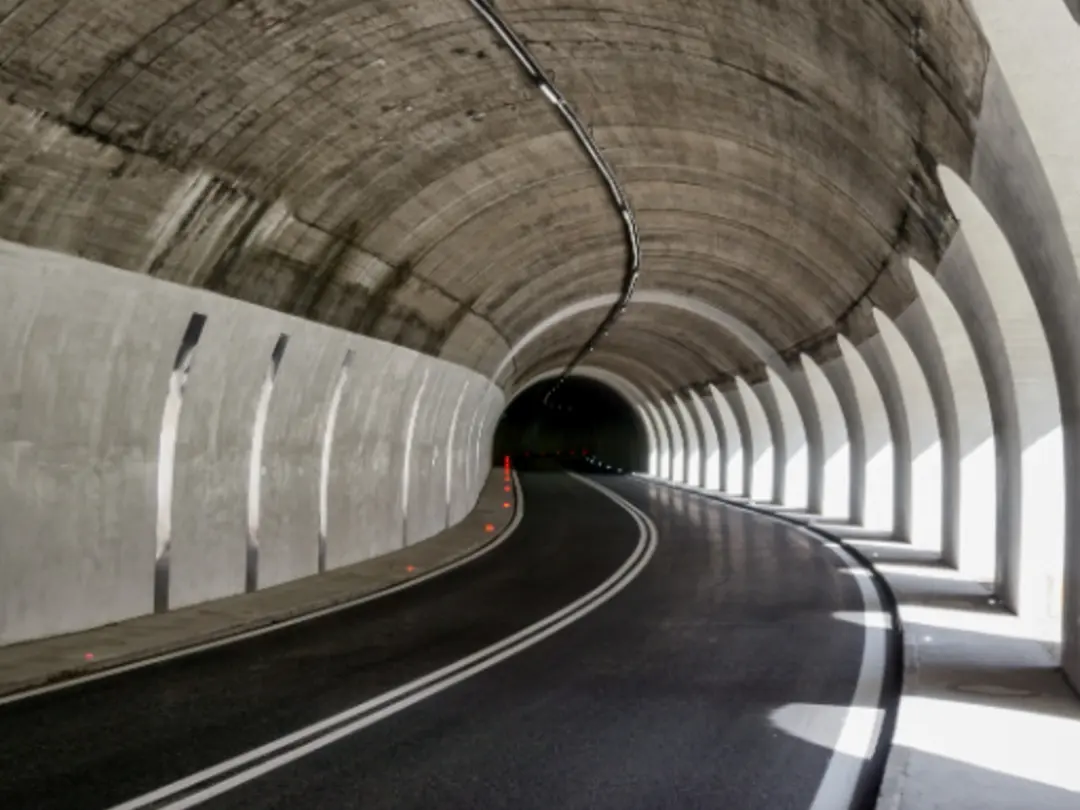 Concrete tunnel structure with curved roadway, showcasing durable, high-performance concrete used in infrastructure applications