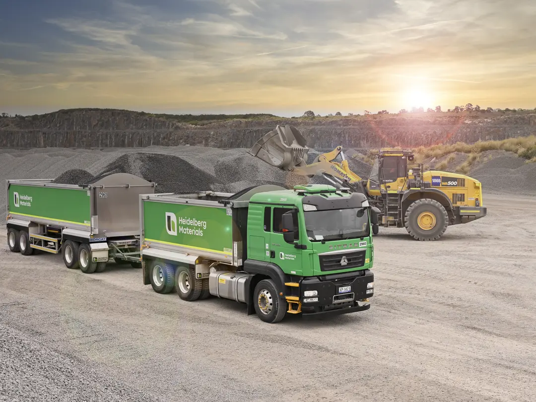 Heidelberg Materials tipper truck being loaded by a wheel loader at an aggregates quarry in Australia.